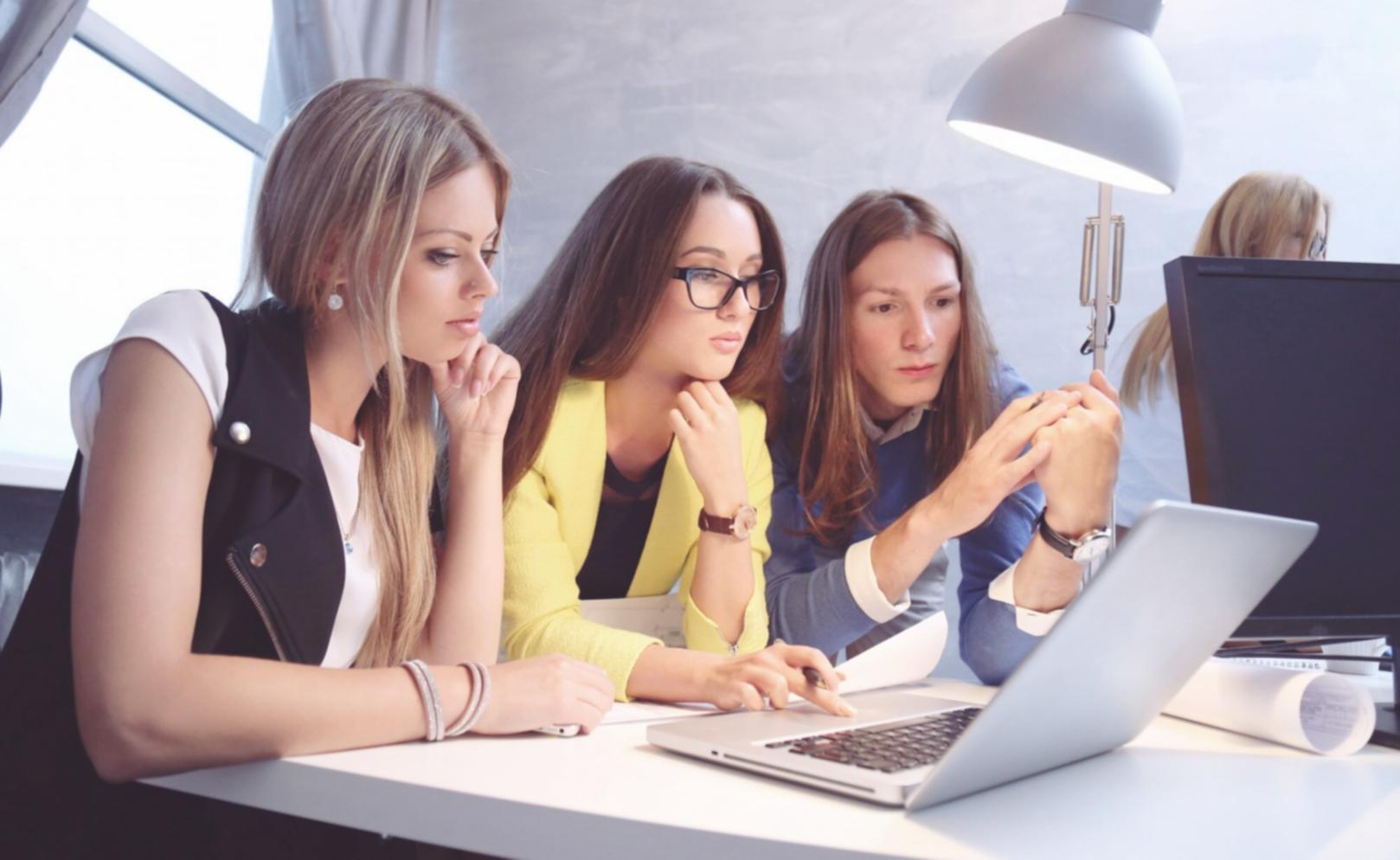 Students working collaboratively on budget analysis in modern classroom setting